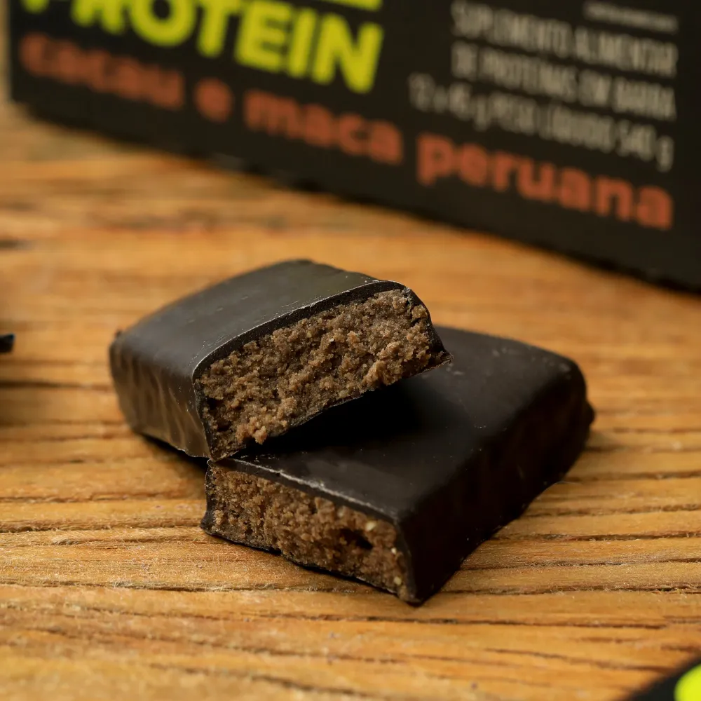 Barra de Proteína biO2, cortada ao meio, vegana, sem glúten, sabor cacau e maca peruana, 45 gramas.